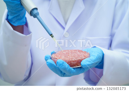 Scientist holding Petri dish with meat in science laboratory for food product development. Scientist holding Petri dish with meat in science laboratory for food product development. 132085173