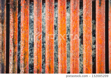 Close-up of rusty metal grill texture with vertical lines and corrosion details 132085209