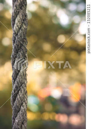 Close-up of a rough rope with soft bokeh background symbolizing strength and connection Close-up of a rough rope with soft bokeh background symbolizing strength and connection 132085211