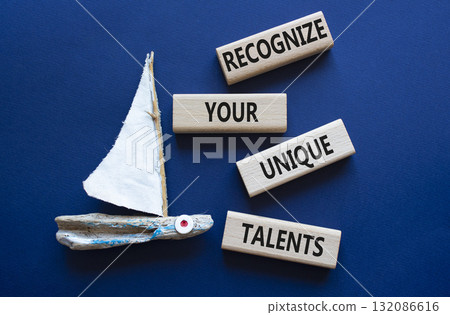 Unique Talents symbol. Concept words Recognize Your Unique Talents on wooden blocks. Beautiful deep blue background with boat. Business concept. Copy space 132086616