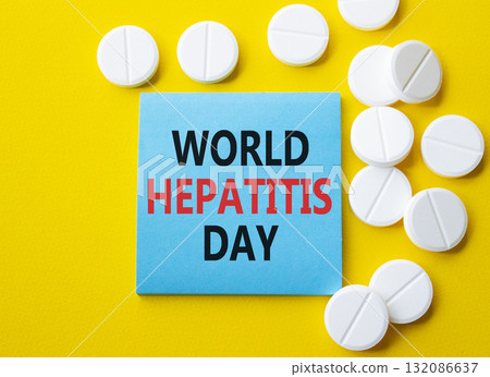 World Hepatitis Day symbol. Concept words World Hepatitis Day on blue note. Beautiful yellow background with pills. Healthcare and World Hepatitis Day concept. Copy space. 132086637