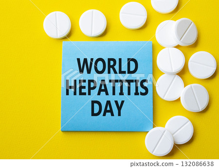 World Hepatitis Day symbol. Concept words World Hepatitis Day on blue note. Beautiful yellow background with pills. Healthcare and World Hepatitis Day concept. Copy space. 132086638