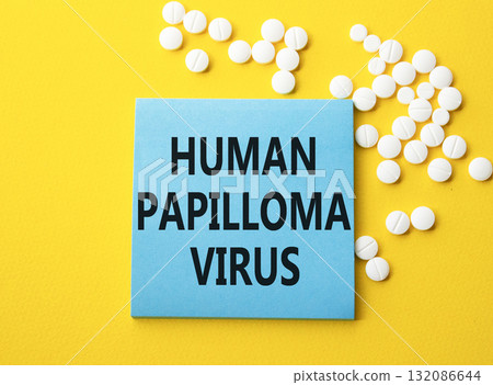 Human Papilloma Virus symbol. Concept word Human Papilloma Virus on blue note. Beautiful yellow background with pills. Medicine and Human Papilloma Virus concept. Copy space Human Papilloma Virus symbol. Concept word Human Papilloma Virus on blue note. Beautiful yellow background with pills. Medicine and Human Papilloma Virus concept. Copy space 132086644