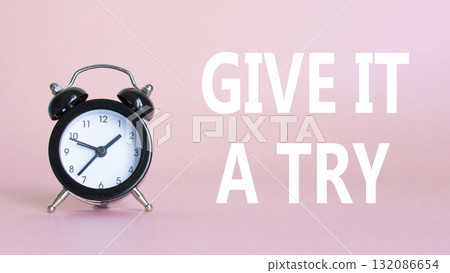 Give it a try symbol. Beautiful pink background with alarm clock. Business and Give it a try concept. Copy space. Give it a try symbol. Beautiful pink background with alarm clock. Business and Give it a try concept. Copy space. 132086654