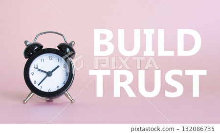 Build trust symbol. Beautiful pink background with alarm clock. Business and Build trust concept. Copy space. Build trust symbol. Beautiful pink background with alarm clock. Business and Build trust concept. Copy space. 132086735