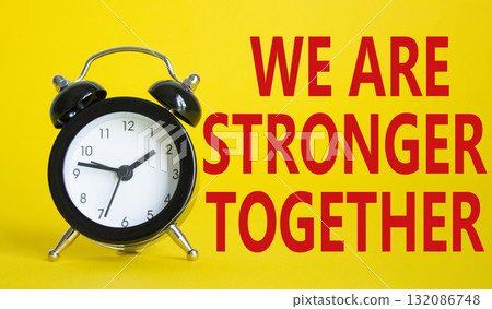 We are stronger together symbol. Beautiful yellow background with alarm clock with words We are stronger together. Business and We are stronger together concept. Copy space. 132086748