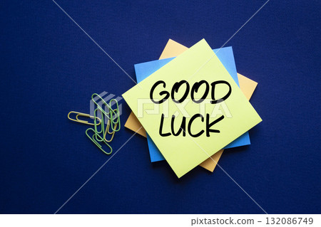 Good luck symbol. Good luck on sticky note. Beautiful deep blue background. Business and Good luck concept. Copy space. 132086749