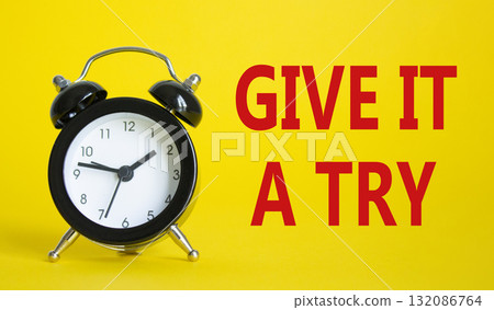 Give it a try symbol. Beautiful yellow background with alarm clock. Business and Give it a try concept. Copy space. 132086764