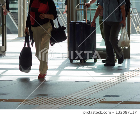 Male and female tourists crossing the east exit of Kanazawa Station on a summer morning Male and female tourists crossing the east exit of Kanazawa Station on a summer morning 132087117