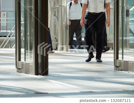 A male office worker leaving the east exit of Kanazawa Station in summer A male office worker leaving the east exit of Kanazawa Station in summer 132087121