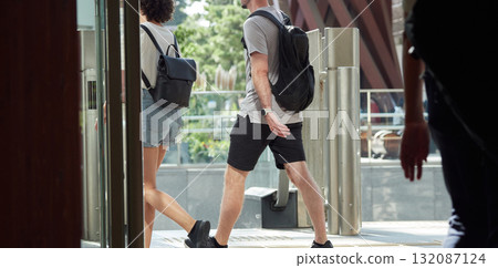 Foreign male and female tourists crossing the east exit of Kanazawa Station on a summer morning 132087124