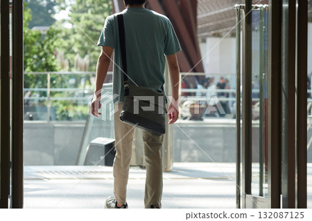 A male office worker leaving the east exit of Kanazawa Station in summer A male office worker leaving the east exit of Kanazawa Station in summer 132087125