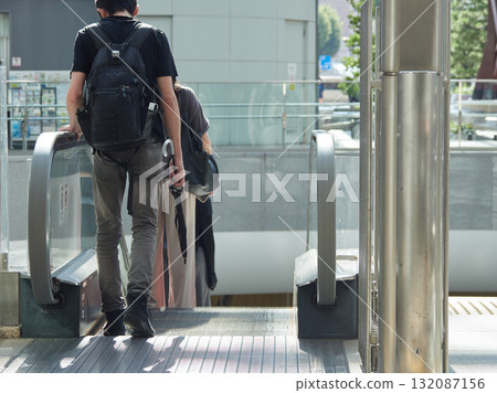 A male office worker leaving the east exit of Kanazawa Station in summer A male office worker leaving the east exit of Kanazawa Station in summer 132087156