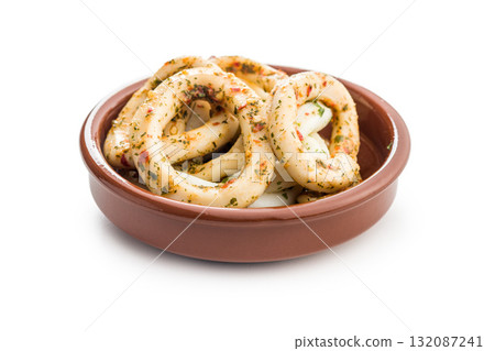 Marinated squid rings in bowl isolated on white background. 132087241