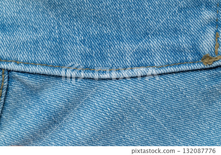 Blue denim texture with seams on the edge of jeans pocket Blue denim texture with seams on the edge of jeans pocket 132087776