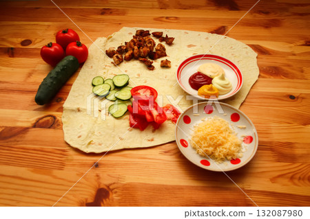 food preparation wooden table shawarma cooking pita bread. shawarma ingredients on wooden table. pita bread close up.Cooking preparation concept 132087980
