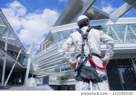 Worker wearing a full harness Worker wearing a full harness 132088509