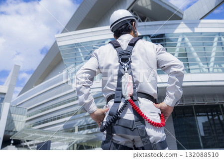 Worker wearing a full harness Worker wearing a full harness 132088510