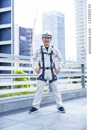 Worker wearing a full harness Worker wearing a full harness 132088534