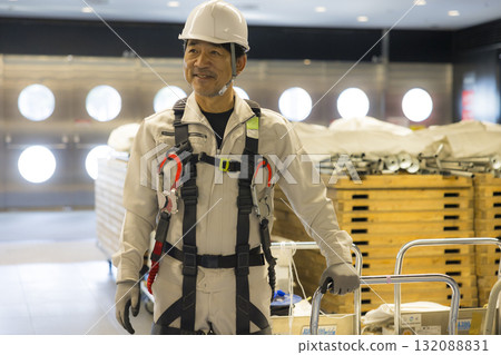 Worker wearing a full harness 132088831