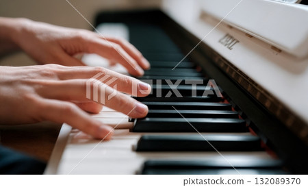 Hands Playing Piano Keys Close-up with Motion Blur for Music Learning and Education Content 132089370