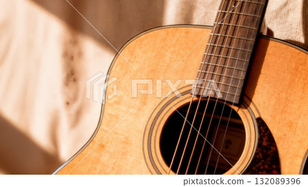 Acoustic Guitar Close-up with Warm Natural Light for Music Production and Creative Content Acoustic Guitar Close-up with Warm Natural Light for Music Production and Creative Content 132089396