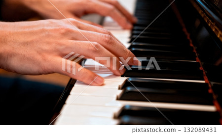 Hands Playing Piano Keys Close-up with Motion Blur for Music Learning and Education Content 132089431