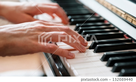 Hands Playing Piano Keys Close-up with Motion Blur for Music Learning and Education Content 132089440