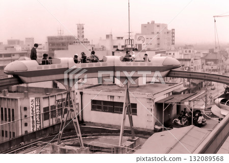 1960s: Rooftop amusement park at Daruma-ya Seibu department store in Fukui | Children playing on the monorail and pedal cars | 132089568