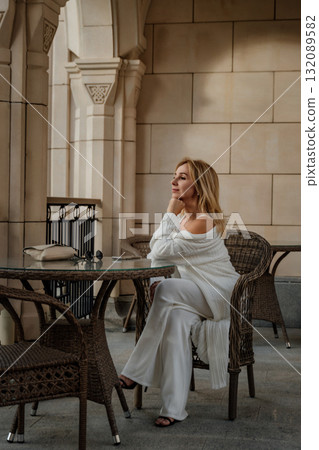 Woman Sitting Cafe Table White Outfit Fashionable Lifestyle Woman Sitting Cafe Table White Outfit Fashionable Lifestyle 132089582