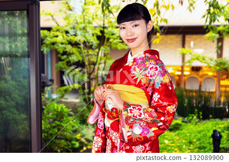 Japanese woman wearing a furisode kimono in a Japanese-style room 132089900