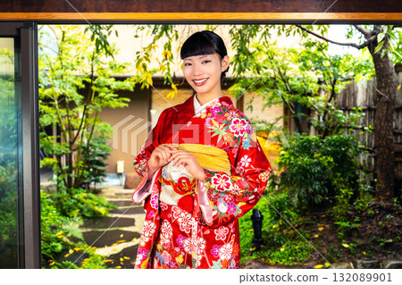 Japanese woman wearing a furisode kimono in a Japanese-style room 132089901