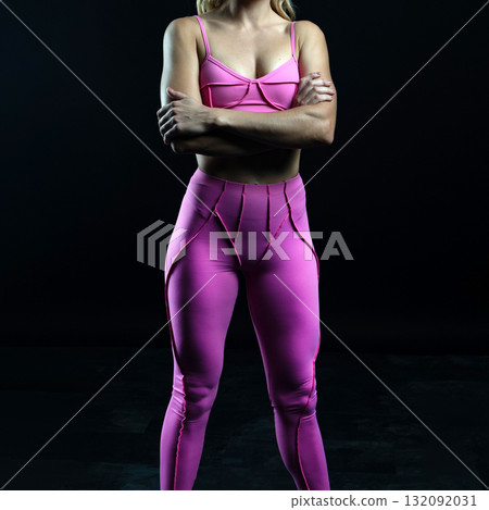 athletic female body in pink sportswear on dark background, fitness woman, athletic girl torso athletic female body in pink sportswear on dark background, fitness woman, athletic girl torso 132092031