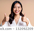 Young woman posing with thumbs up 132092209