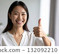 Young woman posing with thumbs up 132092210