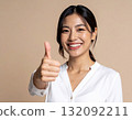 Young woman posing with thumbs up 132092211