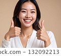 Young woman posing with thumbs up 132092213