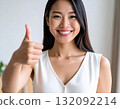Young woman posing with thumbs up 132092214