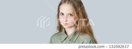 Caucasian young girl with long blonde hair and freckles in olive green shirt Caucasian young girl with long blonde hair and freckles in olive green shirt 132092617