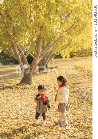 Siblings playing in the autumn park Siblings playing in the autumn park 132092630
