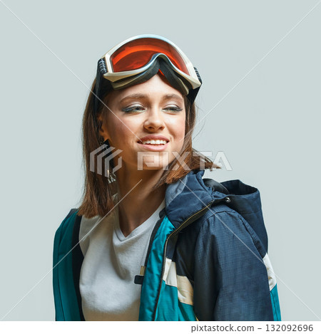 Young caucasian female snowboarder in winter gear with goggles and jacket Young caucasian female snowboarder in winter gear with goggles and jacket 132092696