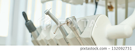 Close-up view of dental tools in clinic setting with focus on handpiece Close-up view of dental tools in clinic setting with focus on handpiece 132092731