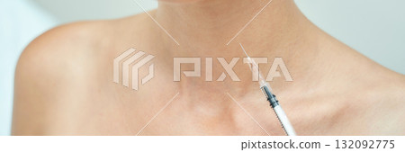 Close-up of female receiving cosmetic injection in neck for skin treatment and 132092775