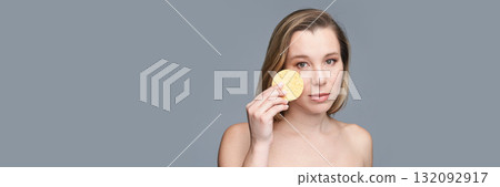 Caucasian adult female with makeup sponge on gray background beauty concept 132092917