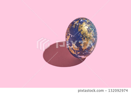 Abstract earth-like sphere with gold accents on pink background casting shadow 132092974