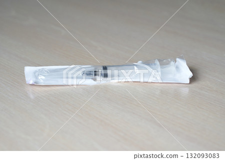 Sealed disposable syringe on wooden surface for medical and healthcare use Sealed disposable syringe on wooden surface for medical and healthcare use 132093083
