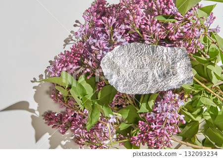 Silver foil on lilac blooms with green leaves and soft shadows in natural light Silver foil on lilac blooms with green leaves and soft shadows in natural light 132093234