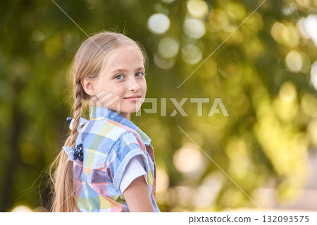 Caucasian young girl with braided hair outdoors in colorful plaid shirt looking Caucasian young girl with braided hair outdoors in colorful plaid shirt looking 132093575