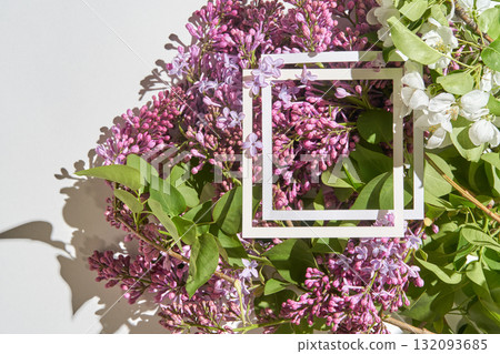 Fresh purple lilacs and white flowers with geometric frame on sunlit background Fresh purple lilacs and white flowers with geometric frame on sunlit background 132093685