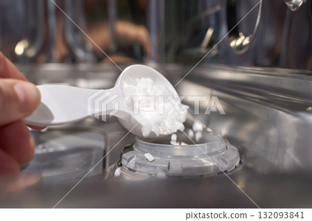 Adding dishwasher salt into appliance compartment for optimal cleaning Adding dishwasher salt into appliance compartment for optimal cleaning 132093841